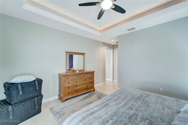 bedroom with crown molding, a tray ceiling, and ceiling fan