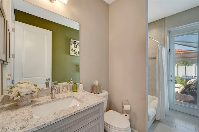 bathroom featuring toilet, curtained shower, vanity, and tile patterned flooring