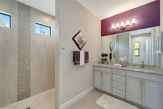 bathroom featuring vanity, tiled shower, and plenty of natural light