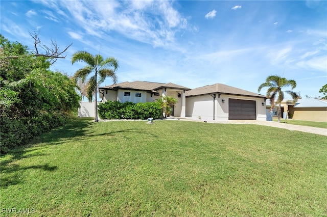 view of front facade with a front yard and a garage