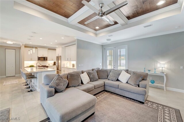 living room featuring sink, ceiling fan, wooden ceiling, crown molding, and light tile patterned floors