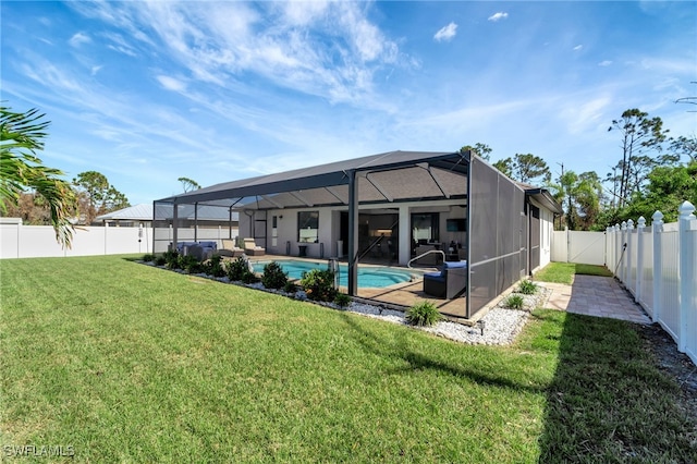 exterior space with a patio area, glass enclosure, a lawn, and a fenced in pool