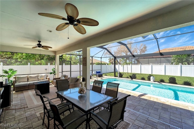 view of swimming pool featuring ceiling fan, a lanai, a patio area, and an outdoor hangout area