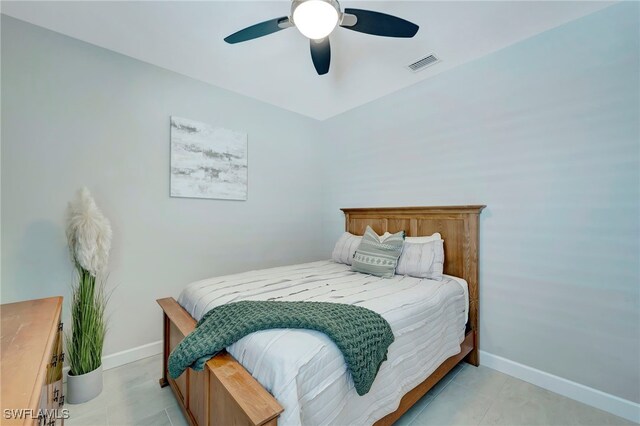 tiled bedroom with ceiling fan