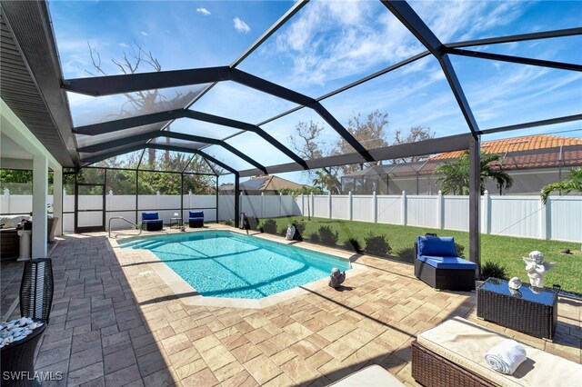 view of pool with a patio and glass enclosure