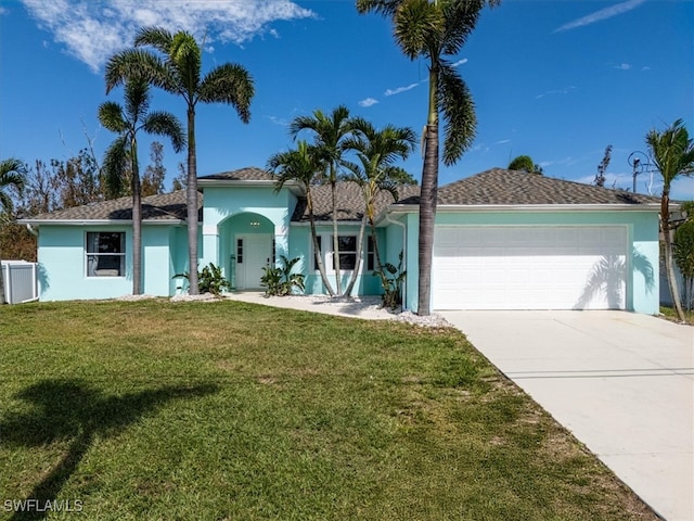 view of front of home with a front yard and a garage