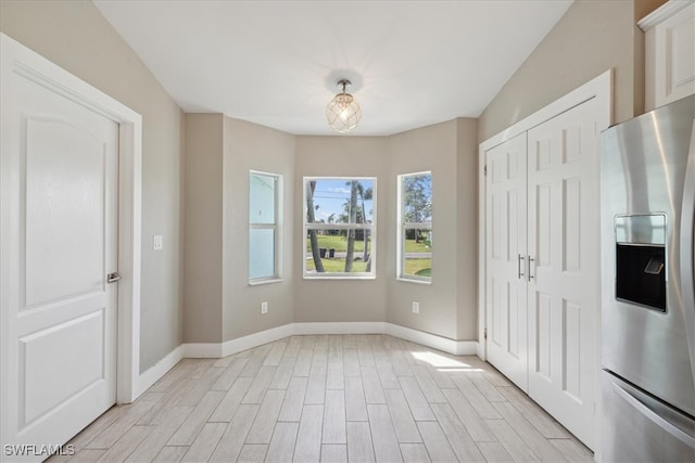 unfurnished dining area featuring light hardwood / wood-style floors