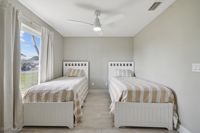 bedroom with light hardwood / wood-style floors and ceiling fan