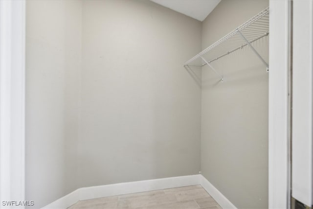 walk in closet featuring light hardwood / wood-style flooring