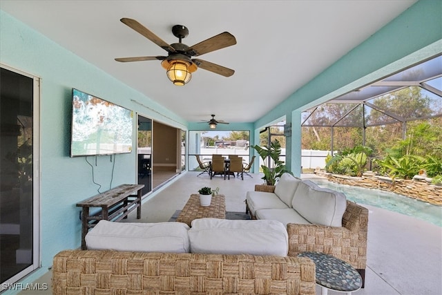 view of patio with ceiling fan, a lanai, and an outdoor living space