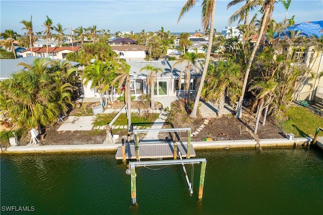 dock area featuring a water view and a patio