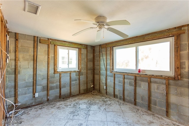 interior space featuring ceiling fan and a wealth of natural light