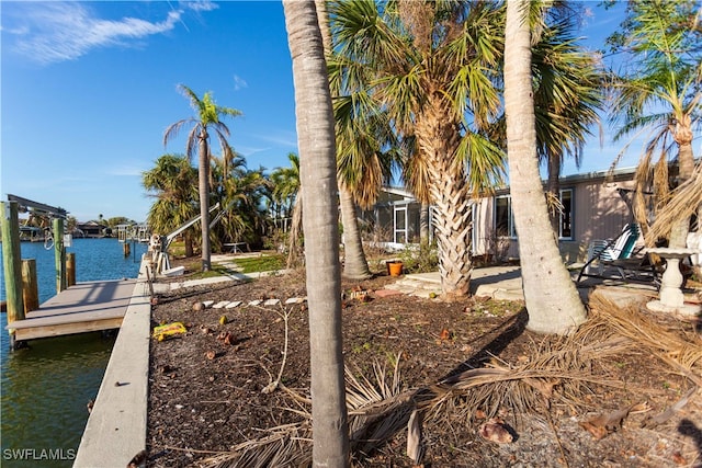 exterior space featuring a dock and a water view