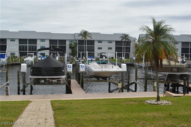 dock area featuring a lawn and a water view