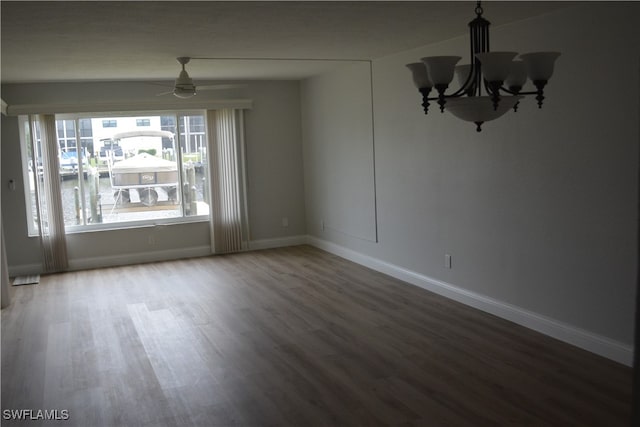 unfurnished dining area with wood-type flooring and a chandelier