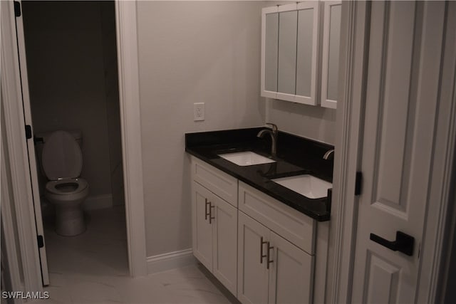 bathroom featuring toilet and vanity