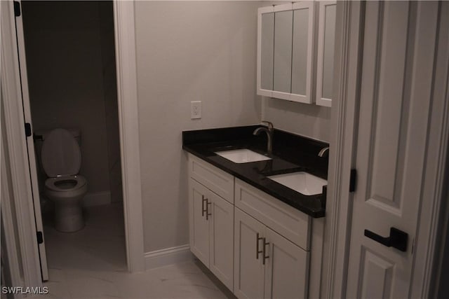 4229 SE 19th Pl Unit 1D, Cape Coral, FL 33904 - full bath featuring toilet, double vanity, baseboards, and marble look tile flooring
