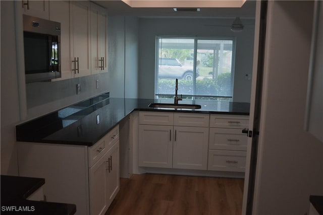 kitchen with sink, white cabinets, and dark hardwood / wood-style flooring