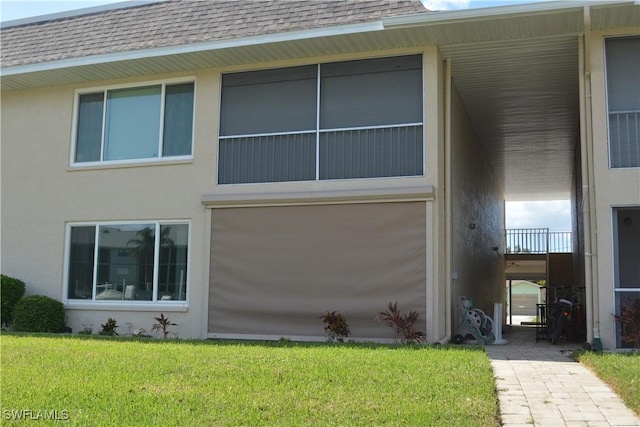 4229 SE 19th Pl Unit 1D, Cape Coral, FL 33904 - view of side of home with a shingled roof, a yard, and stucco siding