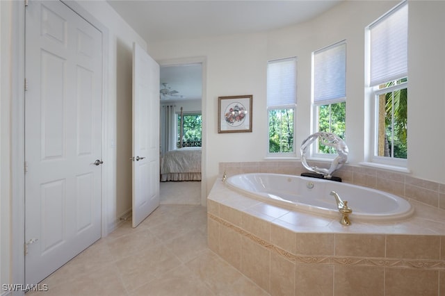 bathroom with tiled tub, plenty of natural light, and tile patterned floors