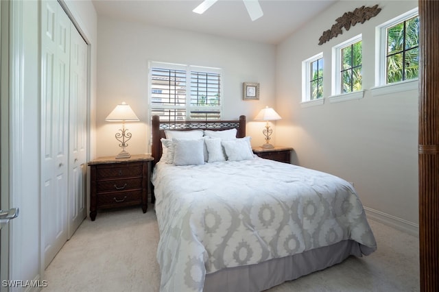 carpeted bedroom featuring multiple windows, a closet, and ceiling fan