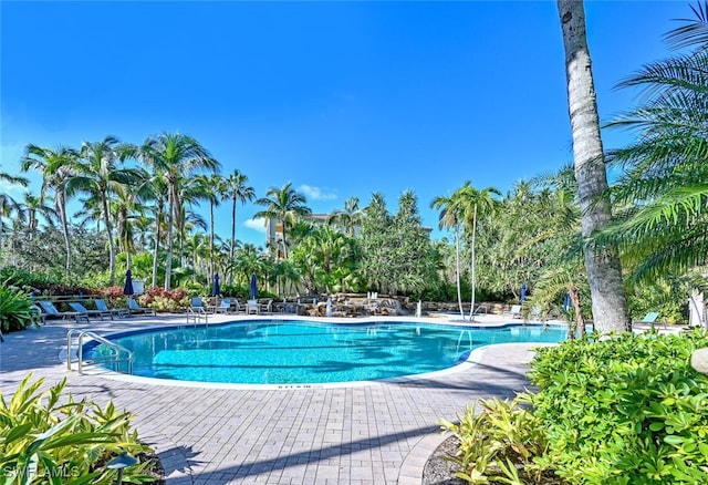 2843 Tiburon Blvd E Unit 7-102, Naples, FL 34109 - community pool featuring a patio