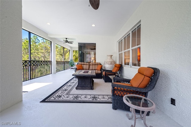 sunroom / solarium featuring ceiling fan