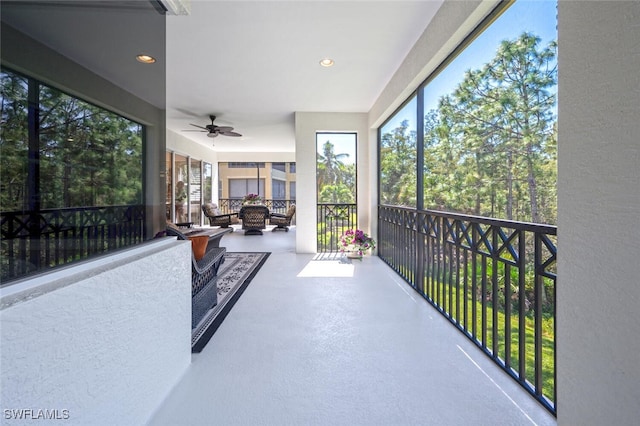 sunroom featuring ceiling fan