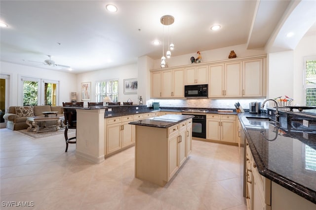 kitchen featuring black appliances, a wealth of natural light, kitchen peninsula, and hanging light fixtures