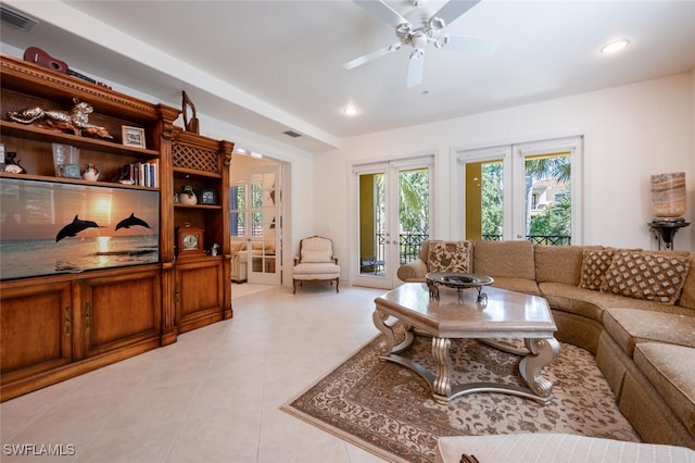 tiled living room with french doors and ceiling fan