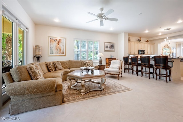 tiled living room featuring ceiling fan