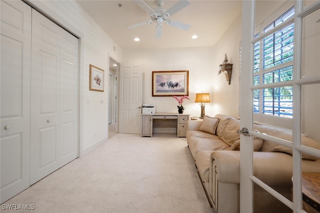 living room featuring french doors, ceiling fan, and light colored carpet