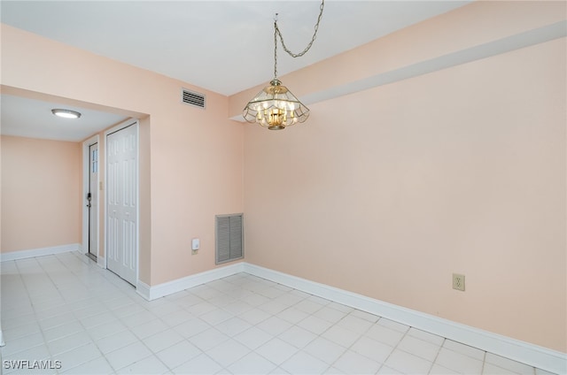 spare room featuring a notable chandelier