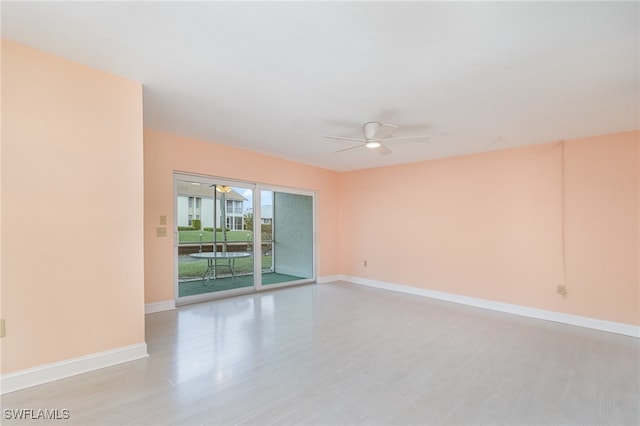 empty room featuring ceiling fan and light hardwood / wood-style flooring