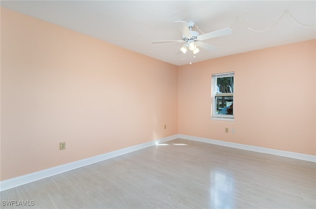 empty room with ceiling fan and light hardwood / wood-style flooring