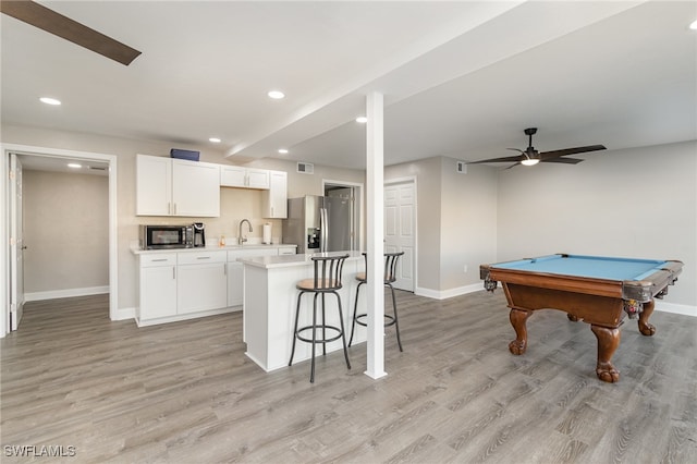 kitchen featuring white cabinets, billiards, ceiling fan, stainless steel fridge, and light hardwood / wood-style floors