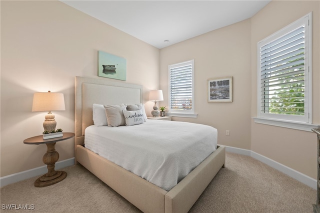 carpeted bedroom with multiple windows