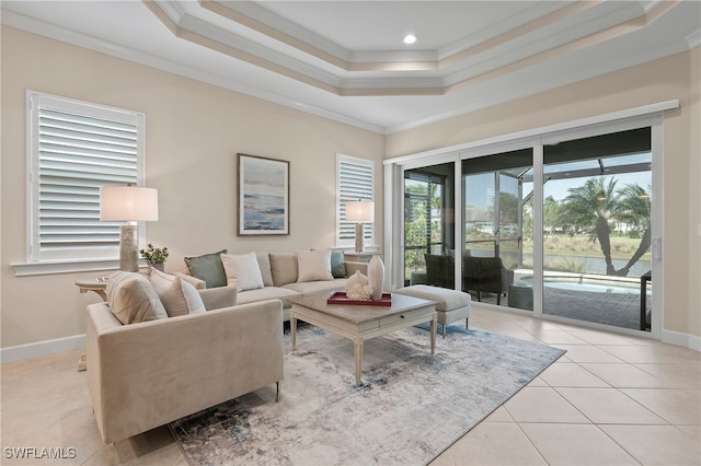 tiled living room with a raised ceiling and ornamental molding