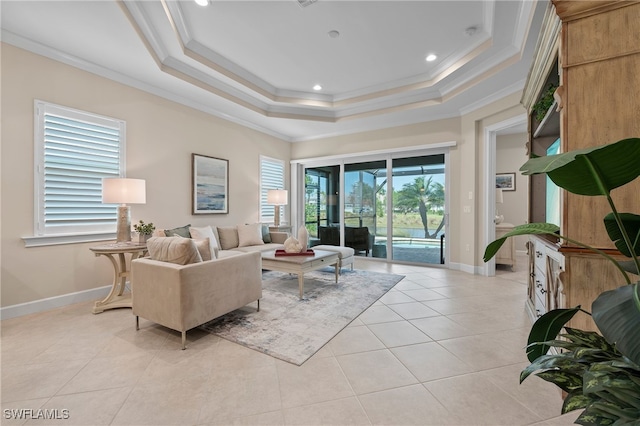 tiled living room with crown molding and a raised ceiling