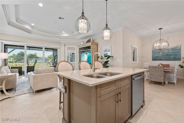 kitchen featuring dishwasher, a kitchen island with sink, sink, light stone countertops, and decorative light fixtures