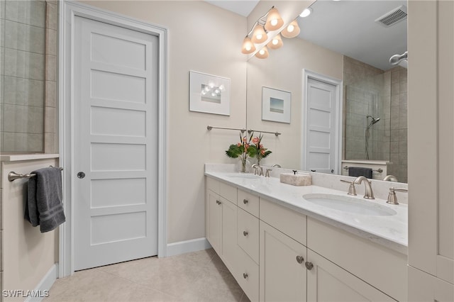 bathroom featuring vanity, tile patterned floors, and tiled shower