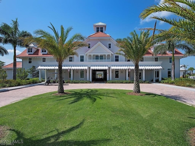 mediterranean / spanish-style house with a front lawn