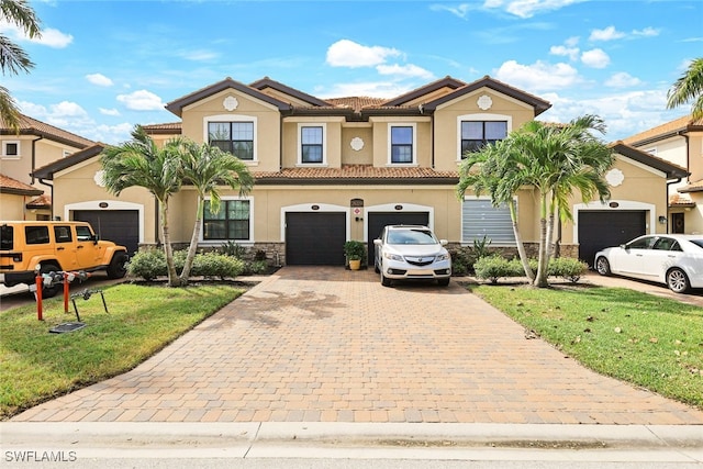 mediterranean / spanish-style home with a garage and a front yard