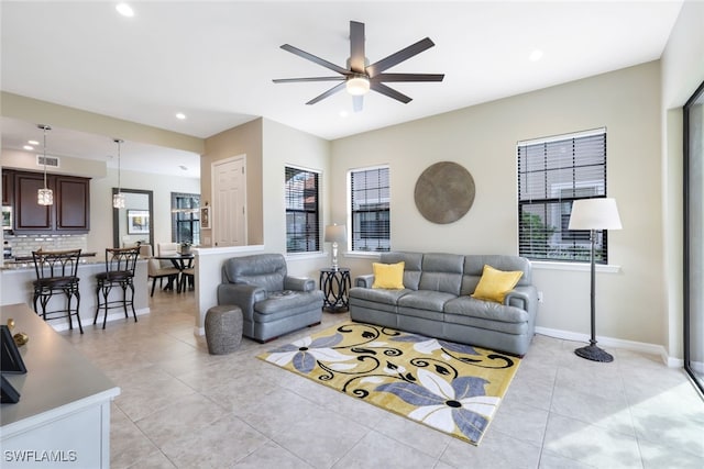 tiled living room with ceiling fan