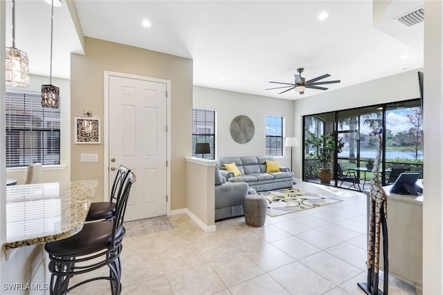 tiled living room featuring ceiling fan