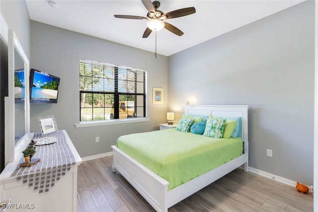 bedroom with light hardwood / wood-style flooring and ceiling fan