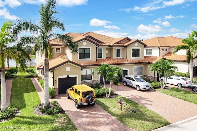 mediterranean / spanish home with a front yard