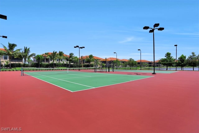 view of tennis court featuring basketball hoop