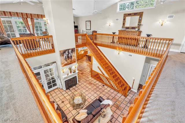 living room with carpet and high vaulted ceiling