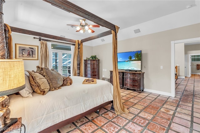 tiled bedroom with ceiling fan and a barn door